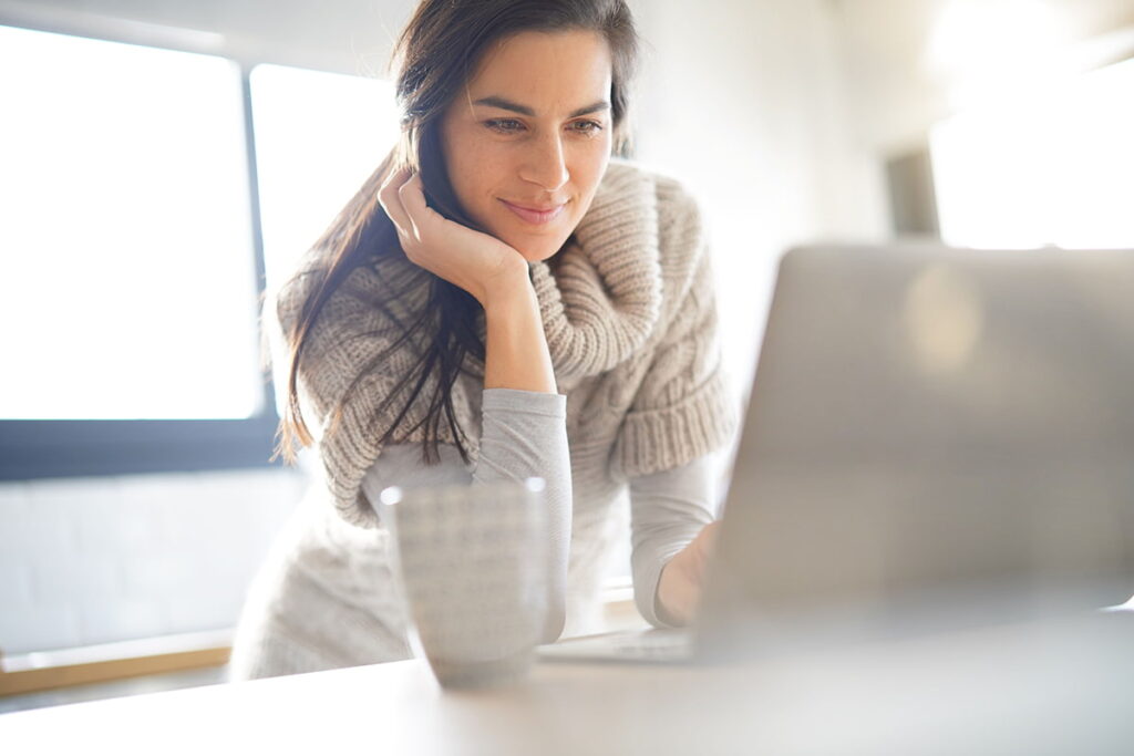 houston plastic surgery model working on her laptop